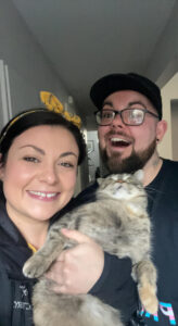 Business management program grad Tj with fiancée Jess and their cat Enid
